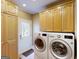 Bright laundry room with washer, dryer, built in cabinets and access door at 709 Prestige Pt, Peachtree City, GA 30269
