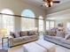 Spacious living room featuring high ceilings, large windows, and comfortable seating at 709 Prestige Pt, Peachtree City, GA 30269