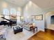 Open-concept living room featuring a fireplace, large arched windows, and plush seating at 709 Prestige Pt, Peachtree City, GA 30269