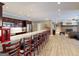 Kitchen bar overlooks recreation and living room with fireplace creating an open and inviting space at 709 Prestige Pt, Peachtree City, GA 30269