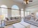 Spacious living room with high ceilings, arched windows and neutral decor at 709 Prestige Pt, Peachtree City, GA 30269