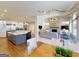 Open floor plan with a stone fireplace, modern lighting and a view of the kitchen at 709 Prestige Pt, Peachtree City, GA 30269