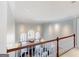 Bright living room with large arched windows, fireplace, and decorative railing at 709 Prestige Pt, Peachtree City, GA 30269