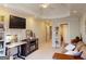 Comfortable living space features a large TV, decorative shelving, and seating area at 709 Prestige Pt, Peachtree City, GA 30269