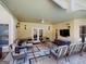 A covered outdoor lounge area with comfortable seating, a ceiling fan, and mounted TV at 709 Prestige Pt, Peachtree City, GA 30269