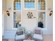 Covered patio boasts decorative lanterns, comfortable seating, and an outdoor sitting area at 709 Prestige Pt, Peachtree City, GA 30269