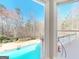 Picture window view of the backyard pool and greenery at 709 Prestige Pt, Peachtree City, GA 30269