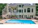 A refreshing pool with an attached deck and lounge seating for relaxing and entertaining at 709 Prestige Pt, Peachtree City, GA 30269