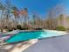 A beautifully designed pool with cool blue water, complemented by a meticulously crafted patio at 709 Prestige Pt, Peachtree City, GA 30269