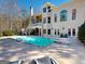 A sprawling backyard pool and sunbathing area, perfect for relaxing and entertaining near the home at 709 Prestige Pt, Peachtree City, GA 30269