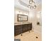 Chic powder room featuring granite countertop vanity, decorative lighting, and neutral color palette at 709 Prestige Pt, Peachtree City, GA 30269
