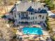Aerial view of a backyard featuring a patio deck, stairs, and in-ground pool at 709 Prestige Pt, Peachtree City, GA 30269