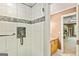 Glass shower with decorative tile accents and a view into an open bedroom space at 709 Prestige Pt, Peachtree City, GA 30269