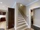 View of a carpeted staircase leading to the upper level of the house with railing and modern lighting at 709 Prestige Pt, Peachtree City, GA 30269
