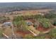 Aerial view of the property showing the home, pool, and surrounding land and neighboring houses at 185 Lady Helen Ct, Fayetteville, GA 30214