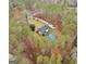 Aerial view of a secluded home with a pool, surrounded by lush greenery and a winding driveway at 185 Lady Helen Ct, Fayetteville, GA 30214