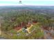 Aerial shot showcasing a home with a pool nestled within a dense forest, offering privacy at 185 Lady Helen Ct, Fayetteville, GA 30214