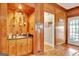 Cozy bar area with wooden cabinets, glassware shelves, and a sink at 185 Lady Helen Ct, Fayetteville, GA 30214