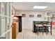 Finished basement with a bar area featuring a dark countertop and tiled floor, illuminated by recessed lighting at 185 Lady Helen Ct, Fayetteville, GA 30214