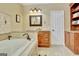 Bathroom featuring a large tub, vanity with sink, storage cabinet, and neutral color scheme at 185 Lady Helen Ct, Fayetteville, GA 30214