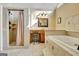 Spa-like bathroom showcasing a tub, glass shower, and lots of natural light from the triangular window at 185 Lady Helen Ct, Fayetteville, GA 30214