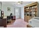 Bedroom with a ceiling fan, a desk, a chair, and built-in shelving is showcased in this image at 185 Lady Helen Ct, Fayetteville, GA 30214