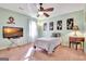 Bedroom with pink carpet, a bed, and a TV with a beach scene is featured in this image at 185 Lady Helen Ct, Fayetteville, GA 30214