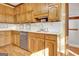 Kitchen with oak cabinets, stainless steel dishwasher, and light countertops at 185 Lady Helen Ct, Fayetteville, GA 30214