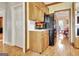 Cozy kitchen features wooden cabinets, a black refrigerator, and opens to an adjacent dining area at 185 Lady Helen Ct, Fayetteville, GA 30214