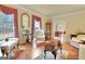 Sunlit living room featuring hardwood floors, neutral walls, and elegant furnishings at 185 Lady Helen Ct, Fayetteville, GA 30214