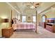 Spacious primary bedroom featuring a four poster bed, tray ceiling, and abundant closet space at 185 Lady Helen Ct, Fayetteville, GA 30214