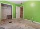 Green bedroom featuring a door to closet, in need of tidying at 3623 Meadow Glen Cir, Ellenwood, GA 30294