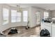 View of the dining area with windows and sliding glass door, showcasing wood-look flooring at 3623 Meadow Glen Cir, Ellenwood, GA 30294