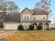 Two-story home with neutral siding, a two-car garage, and a covered front entry at 3623 Meadow Glen Cir, Ellenwood, GA 30294