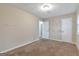 An inviting bedroom includes a doorway to an adjoining room, neutral walls and plush carpeting at 949 Rock Oak Ln, Lawrenceville, GA 30046