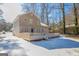 Back of house with large deck overlooking snow covered yard; brick and siding exterior at 3049 Flat Shoals Rd, Atlanta, GA 30349