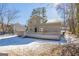 Back exterior of a two-story home featuring a large back deck and a snow-covered yard at 3049 Flat Shoals Rd, Atlanta, GA 30349