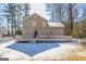 Rear exterior of a two-story house featuring a large back deck and snow-covered backyard at 3049 Flat Shoals Rd, Atlanta, GA 30349