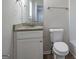 Modern bathroom featuring a granite countertop, white cabinets, and a toilet at 3049 Flat Shoals Rd, Atlanta, GA 30349