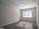 Neutral bedroom filled with natural light from the bright window and featuring carpeted floors at 3049 Flat Shoals Rd, Atlanta, GA 30349
