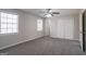 Bedroom featuring soft carpet, neutral walls, a window, and a closet with white double doors at 3049 Flat Shoals Rd, Atlanta, GA 30349