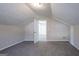 Open bonus room featuring neutral walls, soft carpet, sloped ceilings, and a doorway to another room at 3049 Flat Shoals Rd, Atlanta, GA 30349