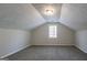 Neutral bonus room with soft carpet, one window and a unique ceiling architecture at 3049 Flat Shoals Rd, Atlanta, GA 30349