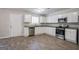 Spacious kitchen boasts stainless steel appliances, granite countertops, and light wood-look floors at 3049 Flat Shoals Rd, Atlanta, GA 30349
