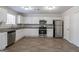 Well-lit kitchen with granite countertops, stainless steel appliances and wood-look vinyl flooring at 3049 Flat Shoals Rd, Atlanta, GA 30349