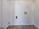 Bright laundry room with white walls, laminate flooring, and washer/dryer hookups at 3049 Flat Shoals Rd, Atlanta, GA 30349