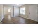 Spacious living room featuring modern flooring, a bright window, and neutral paint at 3049 Flat Shoals Rd, Atlanta, GA 30349