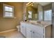 Bathroom with a large vanity, double sinks, and natural light from two windows at 2683 Mariner Way, Villa Rica, GA 30180