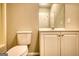 Bathroom showcasing toilet, vanity with cabinet, mirror, and bright lighting at 2683 Mariner Way, Villa Rica, GA 30180