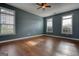 Spacious bedroom features hardwood floors and abundant natural light from multiple windows at 2683 Mariner Way, Villa Rica, GA 30180